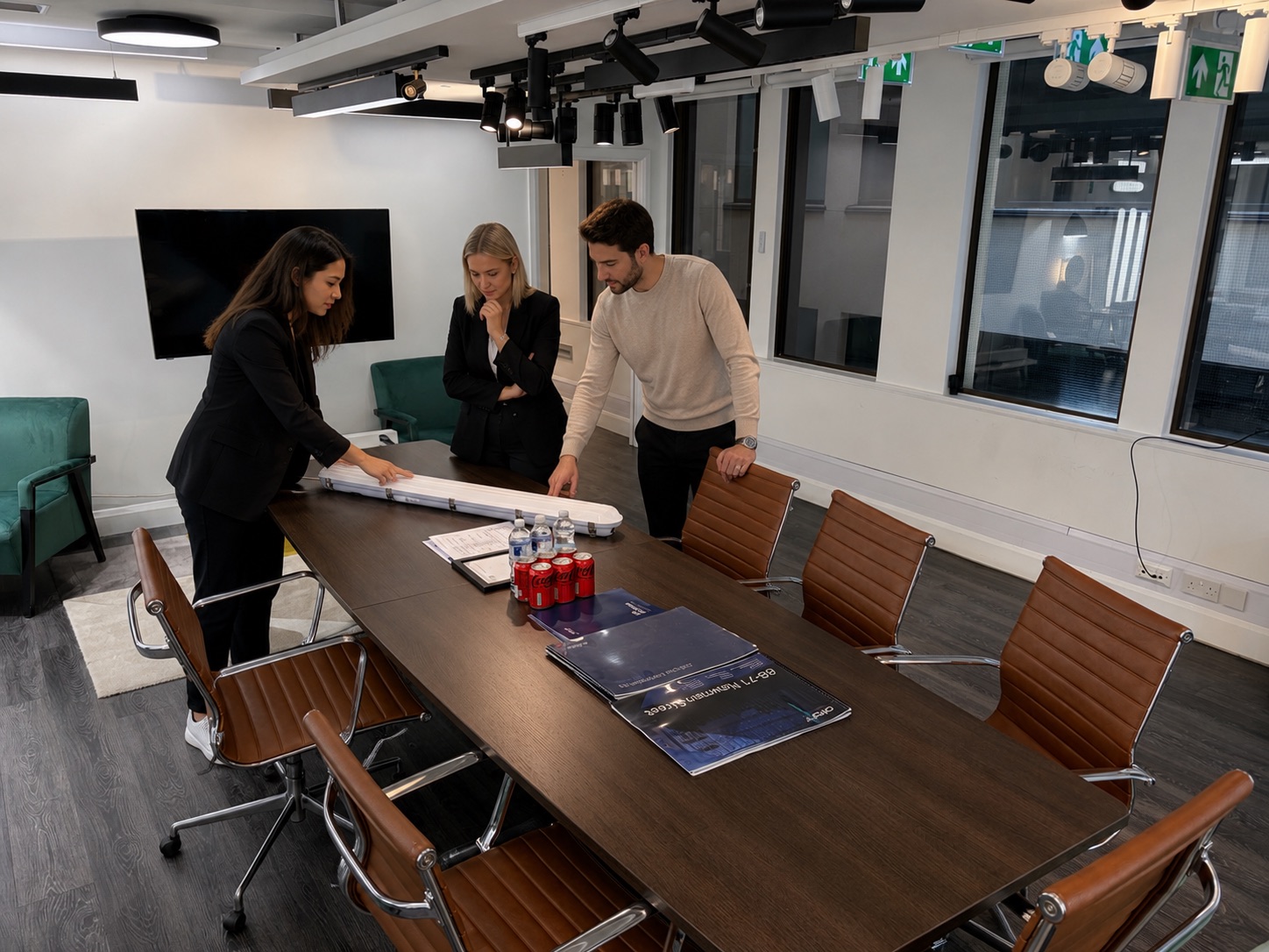 Orlight colleagues reviewing a luminaire sample in the Moorgate showroom